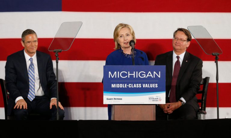 Hillary Clinton speaks at a rally for gubernatorial candidate Mark Schauer, left, and U.S. Senate candidate Gary Peters, right, at Oakland University in Auburn Hills, Mich., Thursday, Oct. 16, 2014. (AP Photo)Â 