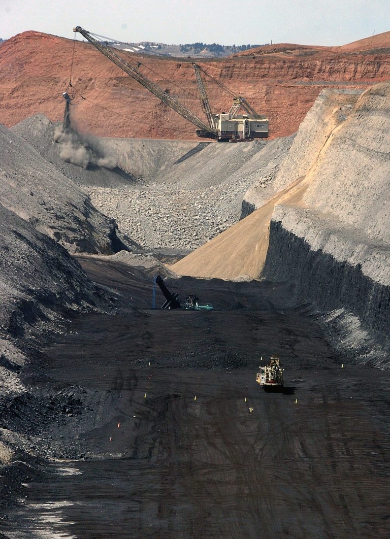 FILE - In this April 4, 2013 file photo shows an 80-foot thick coal seam at Cloud Peak Energy's Spring Creek strip mine near Decker, Mont. From the time coal is blasted from strip mines in remote southeastern Montana to the point where it reaches customers in Asia, the fuel's price gets marked up by five times or more, offering a lucrative emerging market for the companies that ship it overseas. Undervalued coal sales from public lands have cost the U.S. an estimated $62 million in potential lost revenues in recent years, according to a Tuesday report from federal investigators who recommended broad changes to the government's coal leasing program to stem further losses. (AP Photo/Matthew Brown, File)
