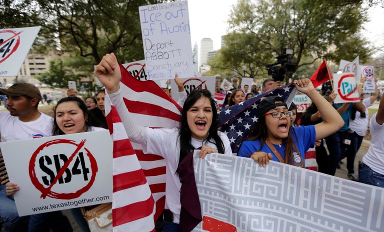 Georgia Cordova of El Paso, Texas, Center, joins other protesters as they take part in a No Ban, No Wall rally to support the rights of immigrants and oppose a border wall and support sanctuary cities, Tuesday, Feb. 28, 2017, at the State Capitol in Austin, Texas. (AP Photo/Eric Gay)