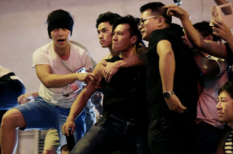 Angry protesters confront each other in Kowloon's crowded Mong Kok district, Saturday, Oct. 4, 2014 in Hong Kong. Clashes broke out Friday as Hong Kong residents and pro-Beijing supporters tried to force pro-democracy activists from the streets they were occupying, reviving the possibility that the weeklong standoff could turn violent despite and attempt by the city's leader to defuse the situation. (AP Photo/Wong Maye-E)