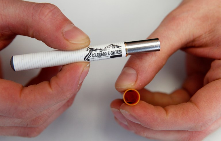 Americans are trading their old-fashioned cigarettes for e-cigarettes, but in this heavily regulated industry, policymakers aren't keeping up. (AP Photo/Ed Andrieski)