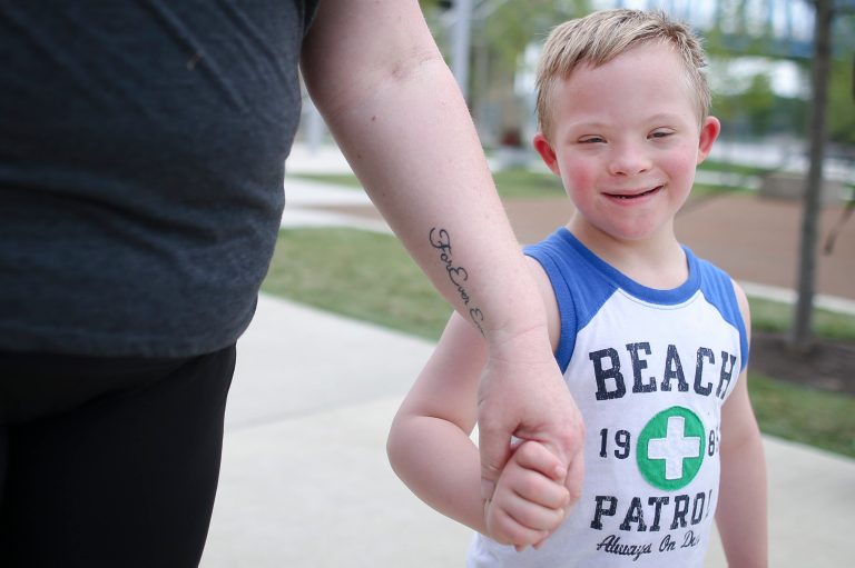 In this Tuesday, July 7, 2015 photo, Steven Heffron, six, walks with his mother, Denise Watts, in Smale Riverfront Park in downtown Cincinnati. (AP Photo)Â 