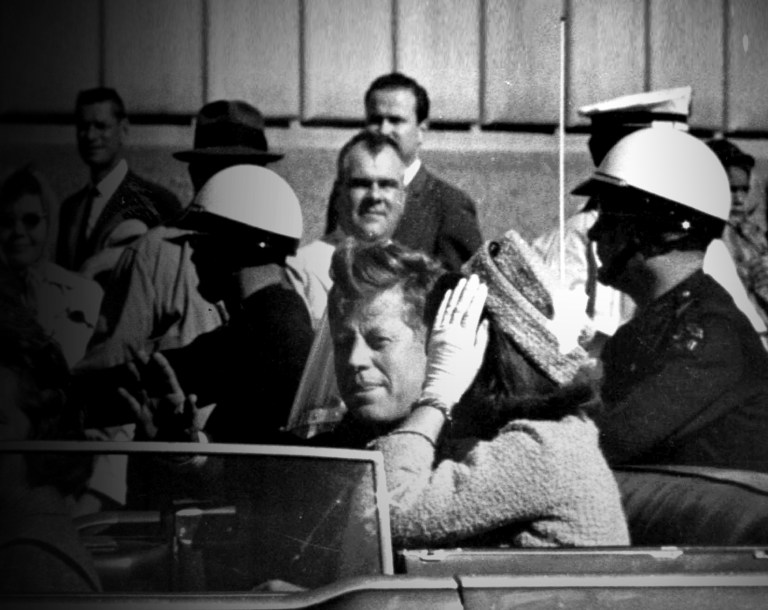 President John F. Kennedy rides in a motorcade with his wife Jacqueline moments before he was shot and killed in Dallas, Tx., Nov. 22, 1963.  Texas Governor and Mrs. John Connally are also in the car.  (AP Photo)