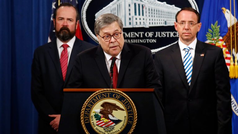 Attorney General William Barr speaks alongside Deputy Attorney General Rod Rosenstein, right, and Deputy Attorney General Ed O'Callaghan, left, about the release of a redacted version of special counsel Robert Mueller's report during a news conference, Thursday, April 18, 2019, at the Department of Justice in Washington.