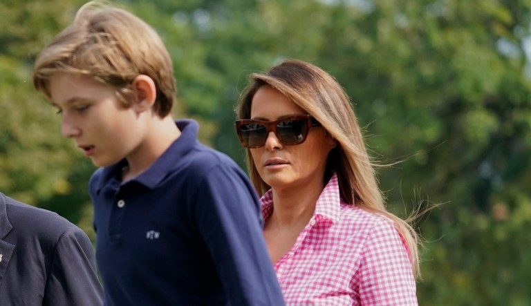 President Donald Trump, first lady Melania Trump and their son Barron Trump, 11, walk across the South Lawn of the White House in Washington, Sunday, Aug. 27, 2017, following their return after spending the weekend at nearby Camp David, Md.