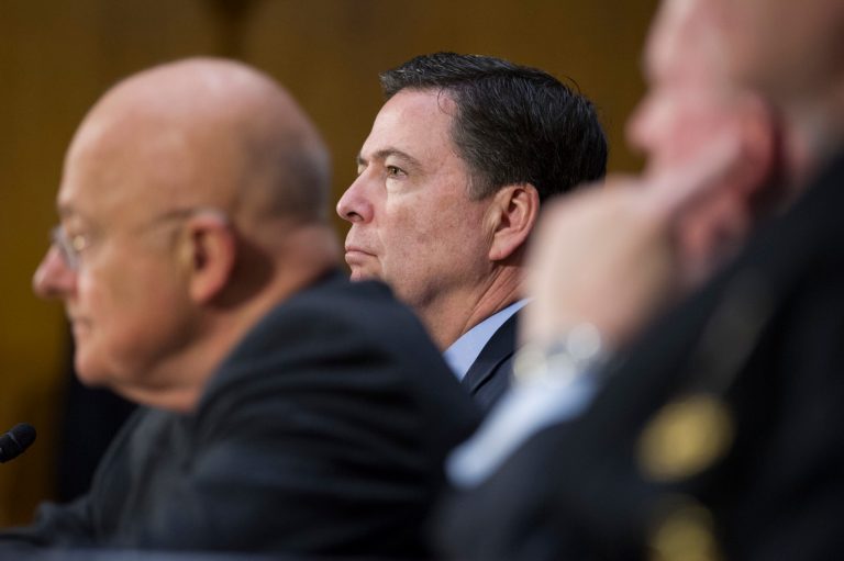2017 AP YEAR END PHOTOS - National Intelligence Director James Clapper, left, and FBI Director James Comey, center, testify on Capitol Hill in Washington on Jan. 10, 2017, before the Senate Intelligence Committee hearing on Russian Intelligence Activities. (AP Photo/Cliff Owen)