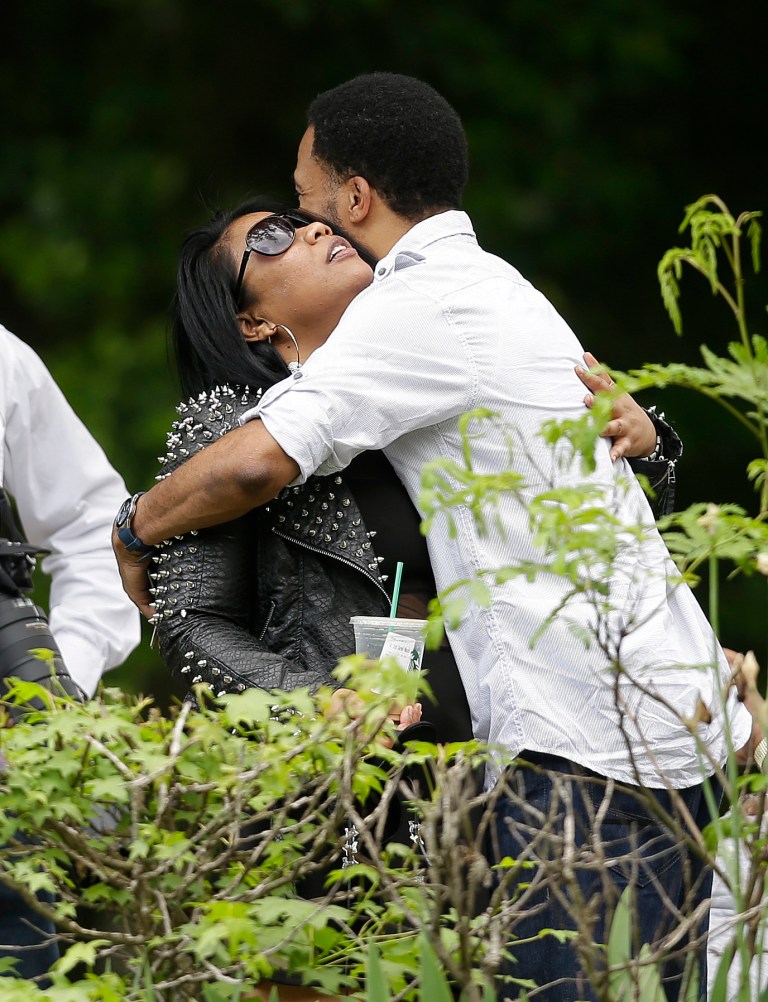 Mourners embrace outside a viewing for music artist Chris Kelly, Wednesday, May 8, 2013, in Atlanta. Kelly, who was part of the duo Kris Kross, died last Wednesday. He was 34. (AP Photo/John Bazemore)