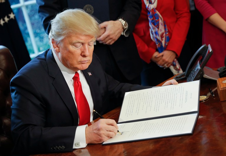 President Trump on Monday signed a revised version of his executive order on travel that excludes Iraqi citizens, legal permanent residents and existing visa holders from a list of foreign nationals who will be prohibited from entering the U.S. for the next 90 days beginning on March 16. (AP Photo/Pablo Martinez Monsivais)