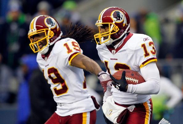 Anthony Armstrong celebrates a touchdown catch with Donte Stallworth against the Seattle Seahawks on Nov. 27, 2011, at CenturyLink Field in Seattle.