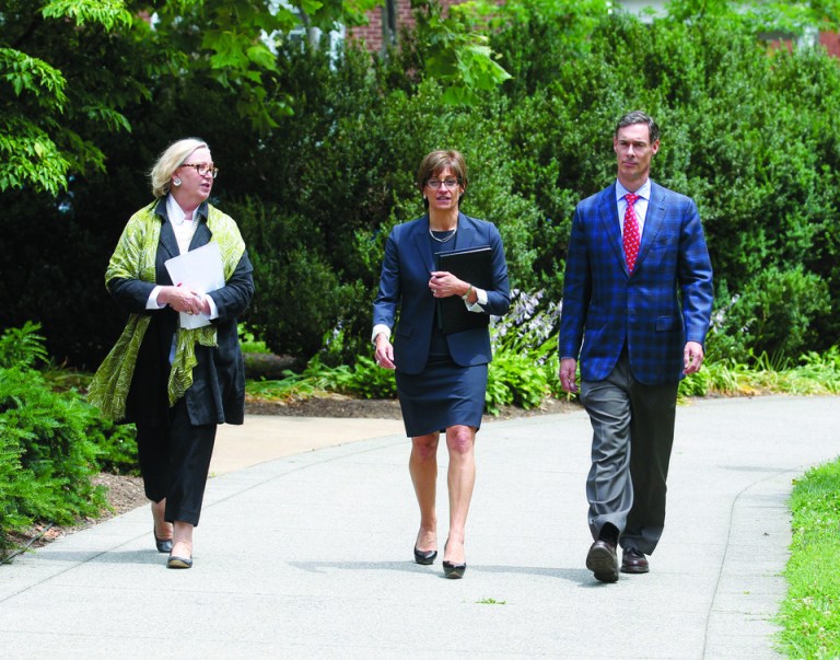 Carol Wood, left, associate vice president for public affairs at the University of Virginia, walks alongside UVA Rector Helen Dragas and Vice Rector Mark Kington to a news conference. (AP Photo)