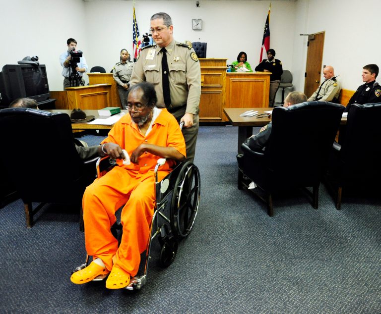  Frank Louis Reeves is wheeled out of the courtroom after his first appearance Tuesday Dec. 4, 2012, in Macon Ga. No bond was set Wednesday afternoon, Dec. 5, 2012, for Reeves who is accused in the death of a woman outside a Gray Highway gas station after his motorized wheelchair bumped her car. (AP Photo/The Macon Telegraph, Woody Marshall)  