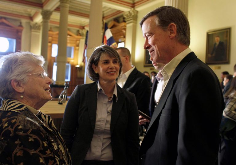 This photo taken Jan. 3, 2013 shows Colorado Gov. John Hickenlooper, right, with Sue Birch, Executive Director of the Colorado Department of Health Care Policy and Financing, center, speaking with an attendee of a news conference where Hickenlooper announced a plan to expand Medicaid coverage for adults as called for by President Barack Obama's federal health care law, at the state Capitol in Denver. The underdog of government health care programs is emerging as the rare early success story of President Barack Obama's technologically challenged health overhaul. A yearslong effort to reach eligible residents apparently succeeded in generating the increased demand. The state has installed self-service kiosks in community clinics, hospitals and libraries to sign people up. And a year ago, nurses statewide agreed to help by promoting Medicaid to low-income uninsured patients. 
