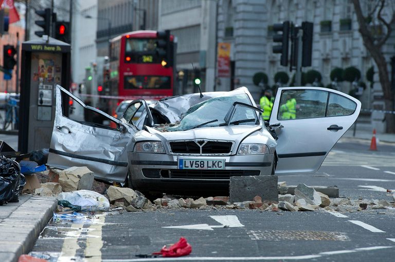 A smashed up car is seen in Kingsway opposite Holborn Tube station in central London, after a woman was killed when large chunks of masonry fell onto a Skoda Octavia vehicle she was in, London, Saturday, Feb. 15, 2014. The taxi driver was killed late Friday in central London opposite Holborn subway station during a heavy windstorm when her car was crushed by falling masonry from a building that partially collapsed, police said. She was identified as Julie Sillitoe, a 49-year-old with three sons. (AP Photo/PA, Laura Lean) UNITED KINGDOM OUT NO SALES NO ARCHIVE