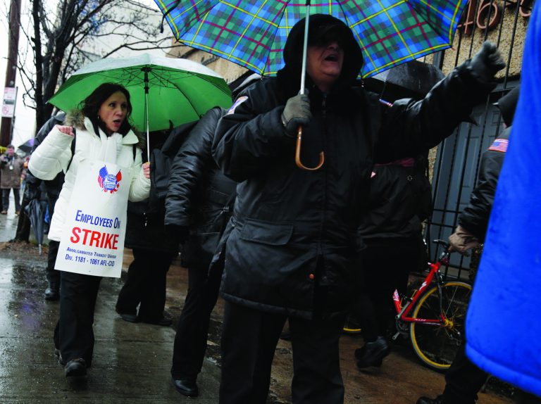 Bus drivers and supporters walk a picket line in front of a bus depot in New York, Wednesday, Jan. 16, 2013. More than 8,000 New York City school bus drivers and matrons went on strike over job protection Wednesday morning, leaving some 152,000 students, many disabled, trying to find other ways to get to school. (AP Photo/Seth Wenig)