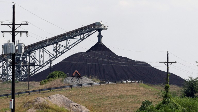 File - This July 29, 2013, file photo shows a Luminant Mining Co. coal mine working in Tatum, Texas. Texas has to cut its carbon emission by 39 percent by 2030 under new federal requirements. The U.S. Environmental Protection Agency announced Monday the state has at least three years to develop a plan to reach the reductions. (AP Photo/LM Otero, File)