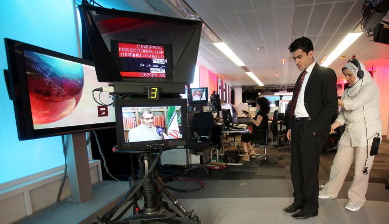 In this Friday June 26, 2009 file photo, BBC Persian service presenter Fardad Farahzad, right, gets ready to present the news, at the corporation's London headquarters.