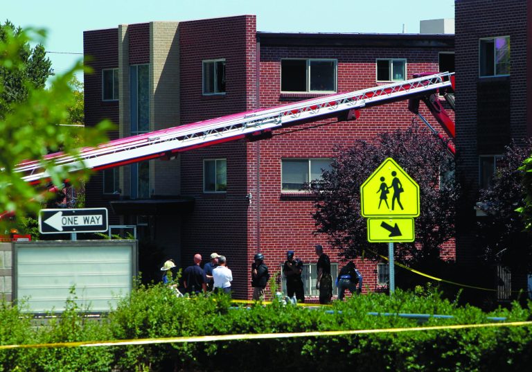 Firefighters and police gather after an explosion could be heard in front the apartment of shooting suspect James Holmes in Aurora, Colo., Saturday, July 21, 2012. Federal authorities detonated one small explosive and disarmed another inside Holmes' apartment, but several other explosive devices remained, said Aurora police Sgt. Cassidee Carlson. Twelve people were killed and dozens were injured in a shooting attack early Friday at a packed movie theater during a showing of the Batman movie, 