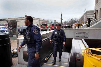 Emergency crews exit the Smithsonian Metro stop, Washington D.C., Tuesday, Dec 20, 2011