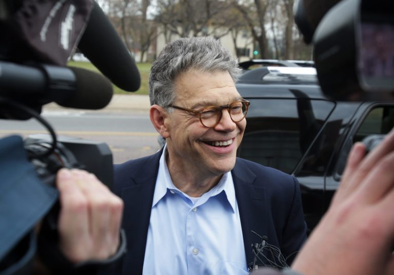 Sen. Al Franken, D-Minn., smiles as he is surrounded by media during a campaign stop Monday in Minneapolis. (AP/Jim Mone)
