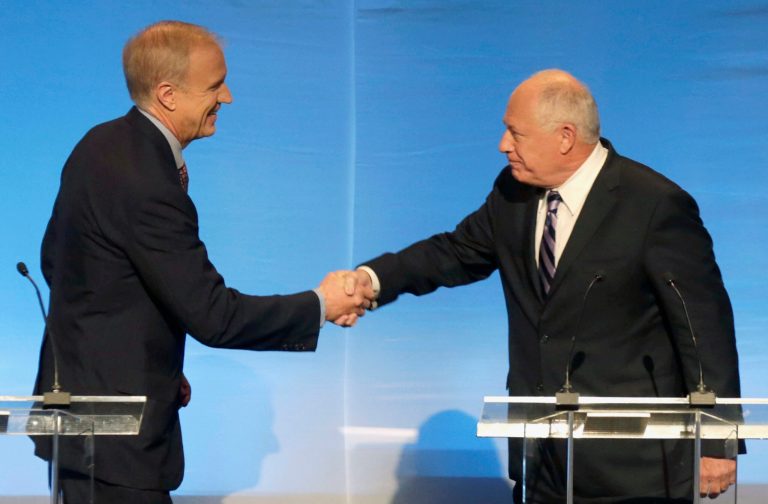 FILE - In this Oct. 14, 2014 file photo, Illinois gubernatorial candidates Republican Bruce Rauner, left, and Democrat Gov. Pat Quinn greet each before a debate in Chicago. The heated race for governor is shattering state records for campaign fundraising and spending. State filings show Quinn and Rauner have had at least $58 million to spend on the general election so far. (AP Photo/Charles Rex Arbogast, File)