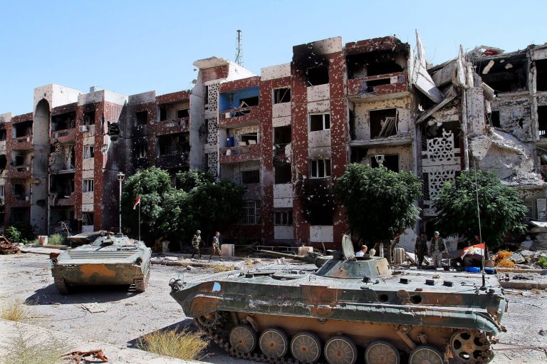 In this photo taken during a Syrian government-led media tour, Syrian soldiers recapture the Damascus suburb of Adra, Syria, Thursday, Sept. 25, 2014. Buildings are seen damaged due to battles between Syrian troops and rebels. (AP Photo)