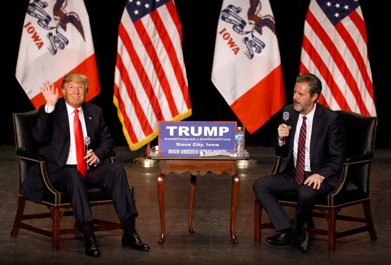 Republican presidential candidate Donald Trump, left, waves to supporters as he speaks alongside Jerry Falwell, Jr., president of Liberty University, during a campaign event at the Orpheum Theatre in Sioux City, Iowa, Sunday, Jan. 31, 2016. (AP Photo/Patrick Semansky)