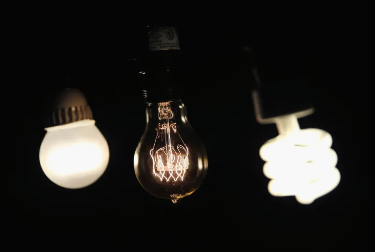 A vintage-style incandescent light bulb, center, is shown with an LED light bulb, left, and a compact florescent light bulb on Dec. 27 in Chicago. On Jan. 1, manufacturers will stop producing the standard 40- and 60-watt incandescent light bulbs in the United States. The 75 and 100 watt bulbs were discontinued in 2013. These incandescent bulbs, which have been in use for more than 100 years, are being replaced by the more energy efficient compact florescent and LED light bulbs. (Getty images photo/Scott Olson)