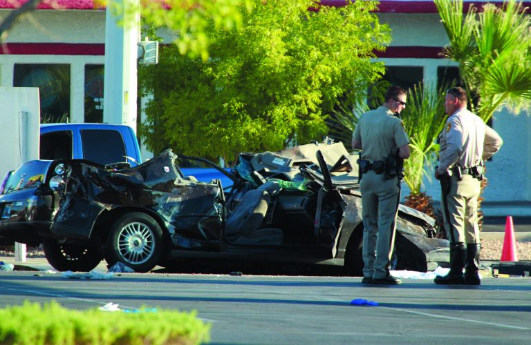 Police officers stands near a vehicle involved in a crash at a bus stop, Thursday, Sept. 13, 2012 in Las Vegas. Police suspect a driver was drunk and speeding Thursday morning when his vehicle went airborne, spun out and plowed into a Las Vegas bus stop, killing four pedestrians and injuring eight others. Las Vegas police officer Laura Meltzer said four people were in the vehicle and had to be extricated following the crash a little before 6:30 a.m. on Spring Mountain Road east of Decatur Boulevard. (AP Photo/Las Vegas Review-Journal, Jeff Scheid) LOCAL TV OUT; LOCAL INTERNET OUT; LAS VEGAS SUN OUT