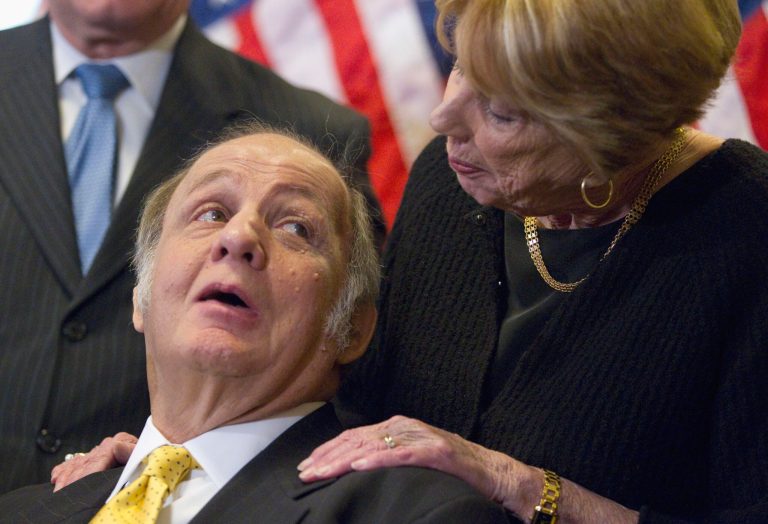 FILE - This March 30, 2011, file photo shows former White House press secretary James Brady, left, who was left paralyzed in the Reagan assassination attempt, looking at his wife Sarah Brady, during a news conference on Capitol Hill in Washington marking the 30th anniversary of the shooting. This week's death of former White House press secretary James Brady, who survived a gunshot wound to the head in a 1981 assassination attempt on President Ronald Reagan, has been ruled a homicide, District of Columbia police said Friday, Aug. 8, 2014. (AP Photo/Evan Vucci, File)