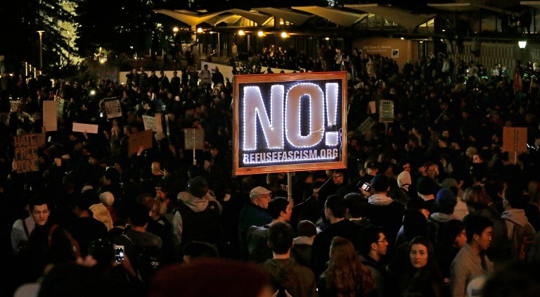Protestors against a scheduled speaking appearance by polarizing Breitbart News editor Milo Yiannopoulos fill Sproul Plaza on the University of California at Berkeley campus on Feb. 1, in Berkeley, Calif. The event was canceled out of safety concerns after protesters hurled smoke bombs, broke windows and started a bonfire. (AP Photo/Ben Margot)