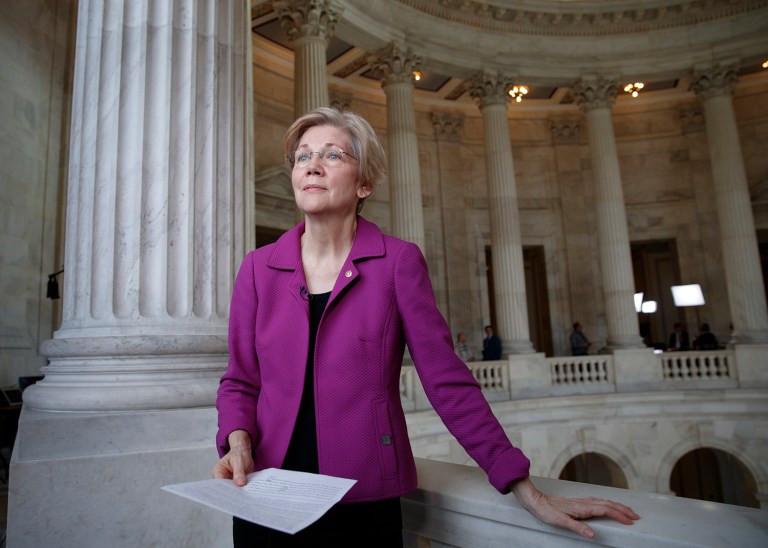Holding a transcript of her speech, Democratic Sen. Elizabeth Warren reacts to being rebuked by the Senate leadership and accused of impugning a fellow senator. (AP Photo/J. Scott Applewhite)