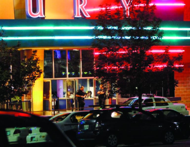 Police are pictured outside of a Century 16 movie theatre where as many as 14 people were killed and many injured at a shooting during the showing of a movie at the in Aurora, Colo., Friday, July 20, 2012. (AP Photo/Ed Andrieski)