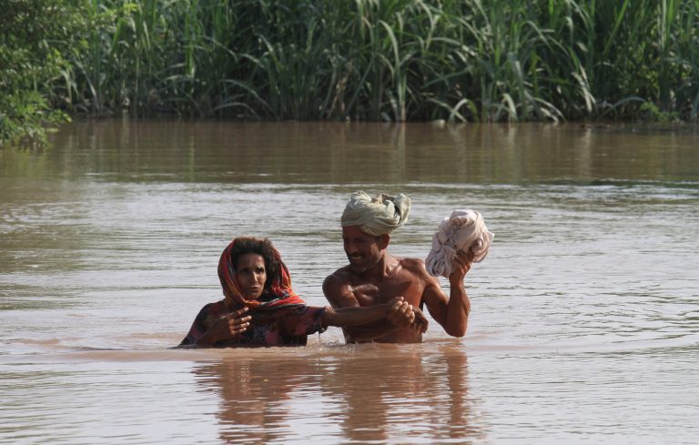 Pakistan villagers wade through floodwaters in district Shorkot near Jhang, Pakistan, Friday, Sept. 12, 2014. The Pakistani military stepped up rescue efforts as floods wreaked havoc in more districts of the country's eastern Punjab province on Friday, leaving hundreds of thousands a people homeless. After destroying hundreds of villages in the Jhang district this week, the floods on Friday hit three more Punjab districts. (AP Photo/K.M. Chaudary)