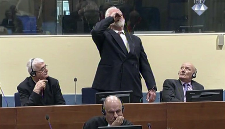 Slobodan Praljak brings a bottle to his lips, during a Yugoslav War Crimes Tribunal in The Hague, Netherlands. Praljak yelled, 