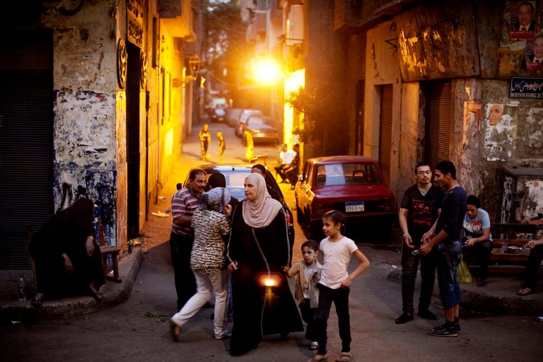   Neighborhood residents outside a polling station in the Abdeen neighborhood of Cairo, Egypt, Sunday, June 17, 2012. For some Egyptians waiting on Sunday in sweltering heat to vote on the second day of presidential elections, their choice has been rendered essentially meaningless with the military poised to hold onto the lion's share of power no matter who wins. (AP Photo/Pete Muller)  