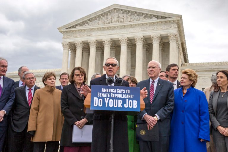 Senate Minority Leader Harry Reid, D-Nev., center, joined at right by Sen. Patrick Leahy, D-Vt., and other Democrats, urges Senate Republicans to relent on their decision to take no action on anyone President Obama nominates to fill the current Supreme Court vacancy. (AP Photo/J. Scott Applewhite)