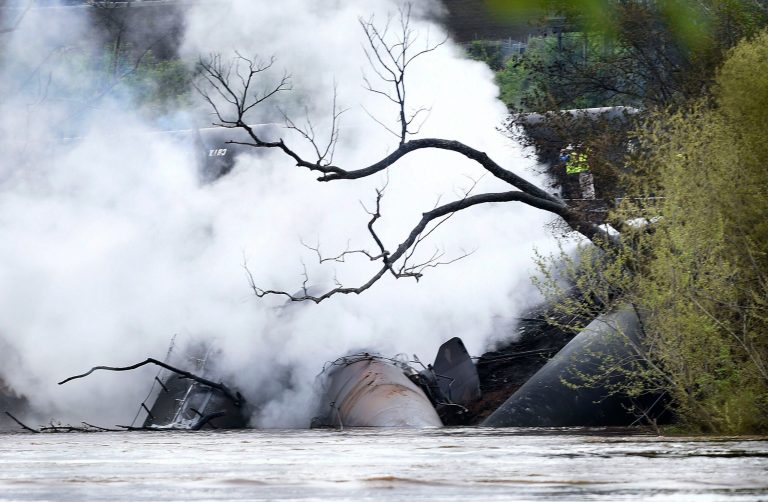 Firefighters and rescue personnel work along the tracks where several CSX tanker cars carrying crude oil derailed and caught fire along the James River in Lynchburg, Va., Wednesday, April 30, 2014. Nearby buildings were evacuated for a time, but officials said there were no injuries and the city on its website and Twitter said firefighters on the scene made the decision to let the fire burn out.  (AP Photo/News & Daily Advance, Autumn Parry)
