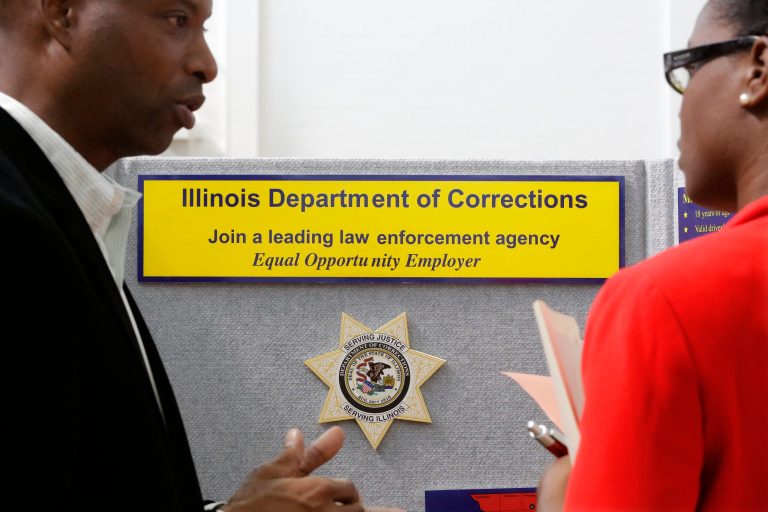 In this Sept. 25, 2014 photo, Illinois Department of Corrections employment recruiter, Forrest Ashby, left, speaks to students attending The Foot in the Door Career Fair at the University of Illinois in Springfield, Ill. The Labor Department releases employment data for September on Friday, Oct. 3, 2014. AP Photo/Seth Perlman)