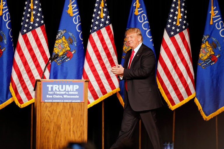 Seller of Trump yarmulkes urges the billionaire candidate to embrace a Hebrew slogan inscribed on his product. (AP Photo/Jim Mone)