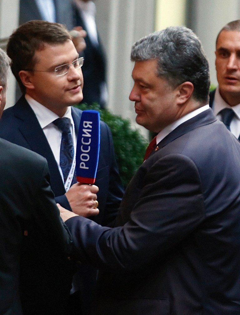 Ukranian President Petro Poroshenko arrives to meet German Chancellor Angela Merkel in Milan, Italy, Thursday, Oct. 16, 2014. Russian President Vladimir Putin is mounting a diplomatic blitz on the sidelines of a summit of European and Asian leaders in a bid to escape Russia's worst crisis with the West since the Cold War. Putin on Friday will discuss Ukraine over breakfast with Ukrainian President Petro Poroshenko and key European leaders on the sidelines of the 10th ASEM summit in Milan. German Chancellor Angela Merkel said she expects to discuss a Ukraine cease-fire deal signed last month, which has reduced hostilities but failed to stop all fighting. (AP Photo/Luca Bruno)