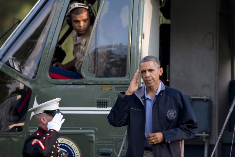 President Barack Obama salutes as he steps from Marine One at the White House, Friday, July 26, 2013, in Washington, as he arrives after spending the day at Camp David with members of his cabinet and their families. (AP Photo/Carolyn Kaster)
