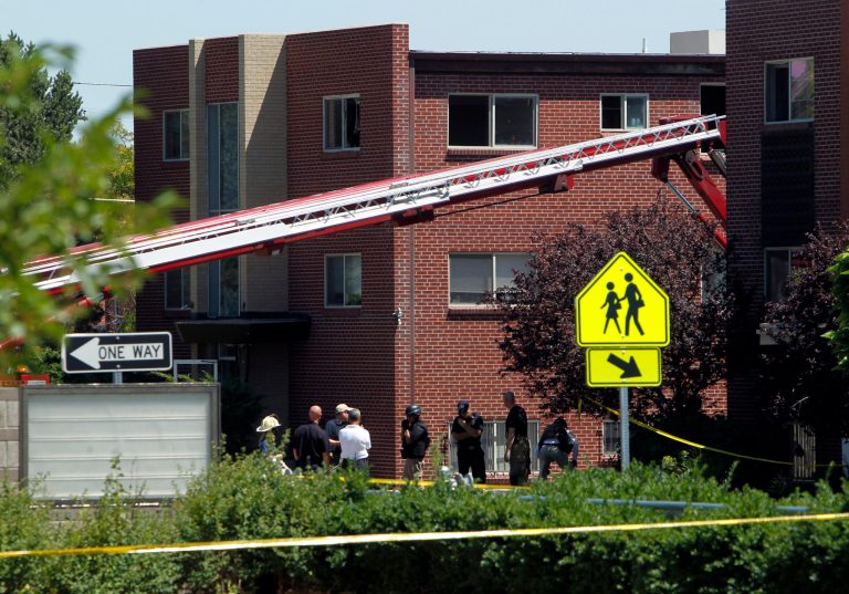 Firefighters and police gather after an explosion could be heard in front the apartment of shooting suspect James Holmes in Aurora, Colo., Saturday, July 21, 2012.  Federal authorities detonated one small explosive and disarmed another inside Holmes' apartment, but several other explosive devices remained, said Aurora police Sgt. Cassidee Carlson. Twelve people were killed and dozens were injured in a shooting attack early Friday at a packed movie theater during a showing of the Batman movie, 