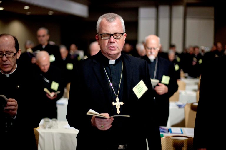   Auxiliary Bishop at Archdiocese of Milwaukee Donald Hying joins a prayer during the U.S. Conference of Catholic Bishops' biannual meeting Wednesday, June 13, 2012, in Atlanta. The national gathering is the bishops' first since dioceses filed a dozen lawsuits against an Obama administration mandate that most employers provide health insurance covering birth control. The rule generally exempts houses of worship, but faith-affiliated hospitals, charities and schools would have to comply. (AP Photo/David Goldman)  
