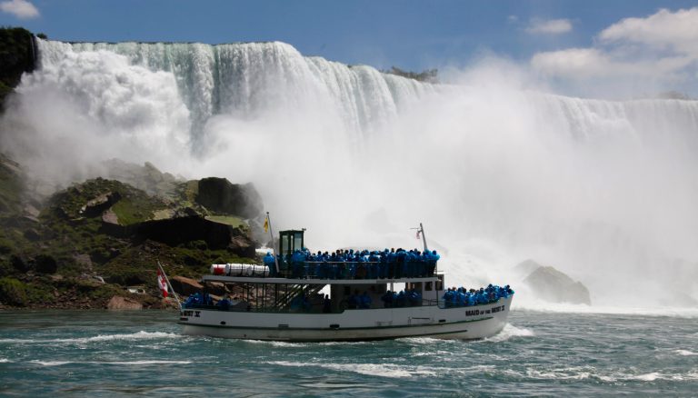   In this Friday, June 11, 2010 photo, tourists ride the Maid of the Mist tour boat at the base of the American Falls in Niagara Falls, N.Y. Gov. Andrew Cuomo has confirmed that a deal has been struck to keep the iconic Maid of the Mist scenic tour boats running from the New York side at Niagara Falls. (AP Photo/David Duprey)  