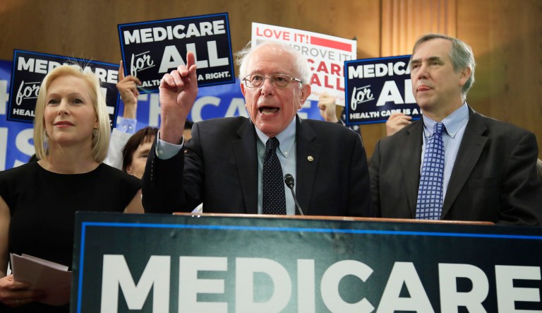 Sen. Bernie Sanders, I-Vt., joined by, Sen . Kirsten Gillibrand, D-N.Y., left, and Sen. Jeff Merkley, D-Ore., front right, introduces the Medicare for All Act of 2019, on Capitol Hill in Washington, Wednesday, April 10, 2019.