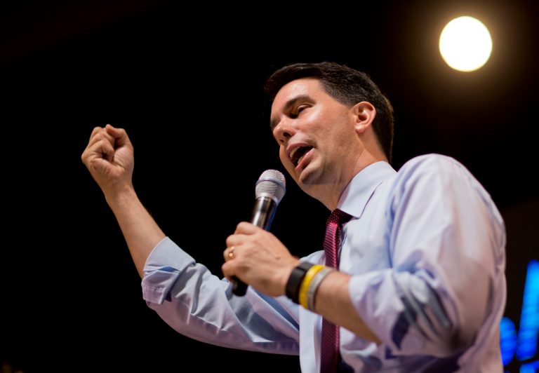 Scott Walker has frequently discussed his battle with public-sector union workers and talked about his service as governor. (AP Photo)Â 