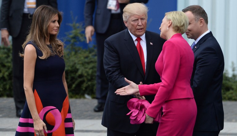 Poland's first lady Agata Kornhauser-Duda, second right, reaches her hand to first lady Melania Trump as President Trump reaches his hand for a handshake after his speech in Krasinski Square, with Polish President Andrzej Duda standing right, in Warsaw, Poland. (AP Photo/Alik Keplicz)