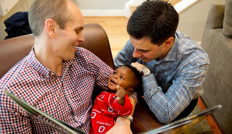 Gregg Pitts, left, and Brooks Brunson read to their son, Thomas Brunson-Pitts, 6 months, before heading to work in the morning at their home in Washington. Married in 2013, Brooks Brunson and Gregg Pitts always knew they wanted to have a family together, and were delighted when they were able to start the adoption process for their son. (AP Photo/Jacquelyn Martin)