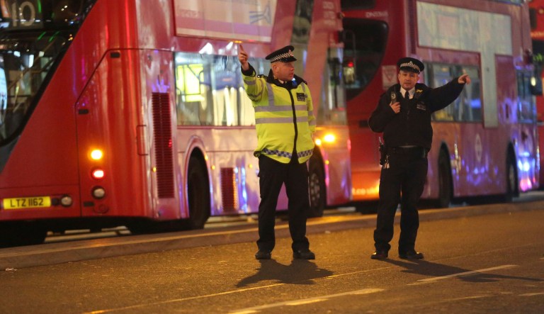 Police officers directing members of the public on Oxford Street in the west end of London after Oxford Circus station was evacuated Friday Nov. 24, 2017. (Isabel Infantes/PA via AP)