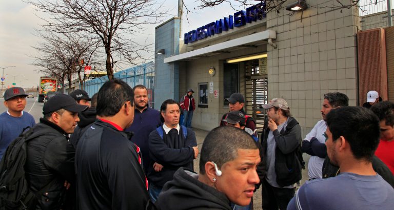 Mexican workers stand outside the Hunts Point Food Distribution Center at the end of their overnight shift, in the Bronx. (AP Photo/Bebeto Matthews)
